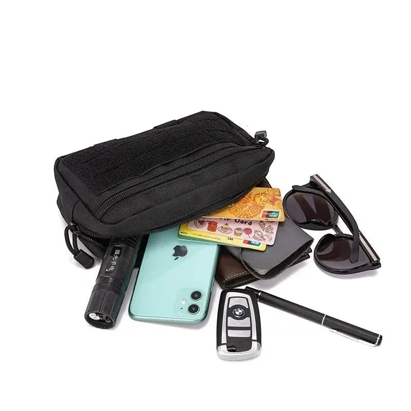 Tailwag Factory black tactical MOLLE pouch made of 1000D nylon, shown with everyday carry items like phone and keys.