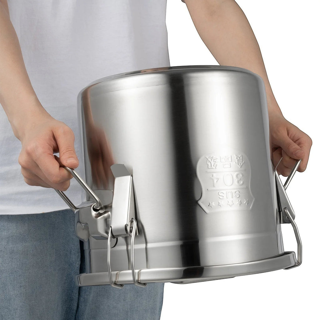 Tailwag Factory 12L stainless steel airtight storage bucket with triple-lock buckles held by a person.