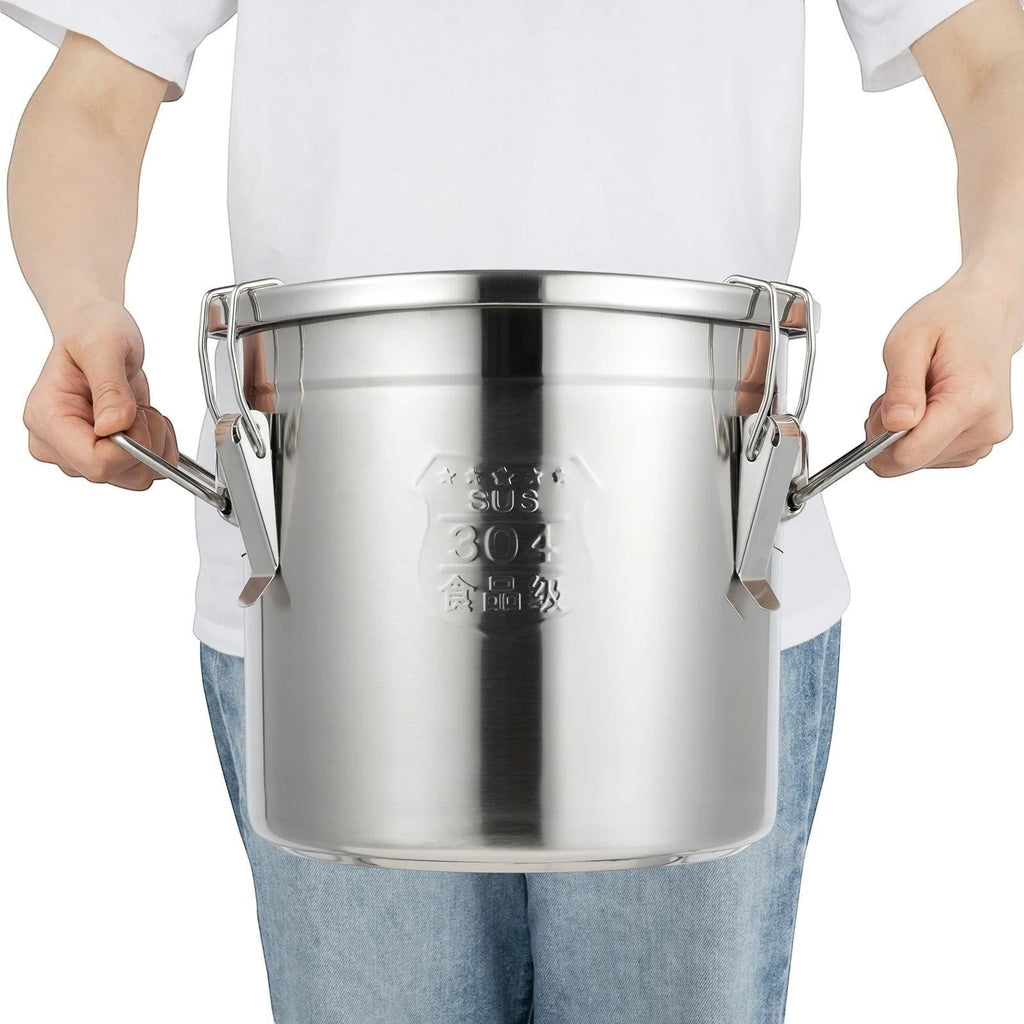 Tailwag Factory 12L stainless steel airtight storage bucket with triple-lock buckles held by a person.