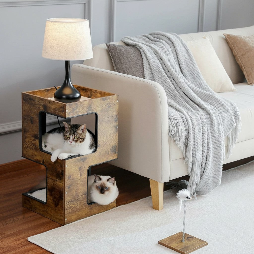 Tailwag Factory modern wood cat condo and side table with two cats resting inside, placed next to a beige sofa.